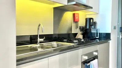 a kitchen with a sink and a stove at Vacay Lettings - Damac Prive studio in Dubai