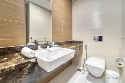 a bathroom with a sink and a toilet at Rustic 2BR at Sparkle Tower 1 Dubai Marina by Deluxe Holiday Homes in Dubai