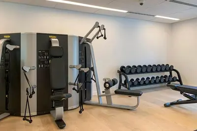 a room with a gym with several tread machines at Frank Porter - Belgravia 3 in Dubai