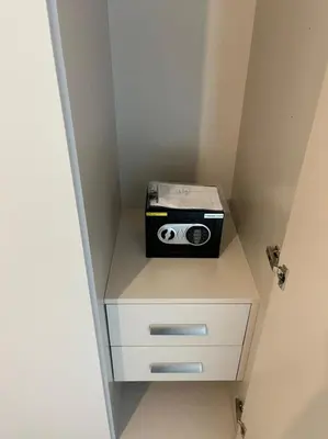 a small cabinet with a radio on top of it at OYO 887 Home A1607 Sobha Creek Vistas - 1BR in Dubai