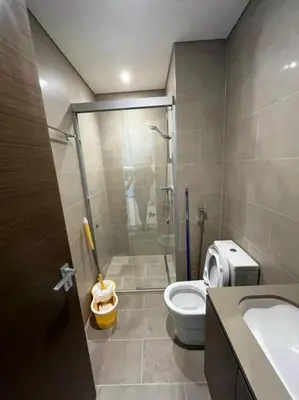 a bathroom with a shower and a toilet and a sink at OYO 887 Home A1607 Sobha Creek Vistas - 1BR in Dubai