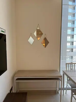 a wooden bench in a room with a window at OYO 887 Home A1607 Sobha Creek Vistas - 1BR in Dubai