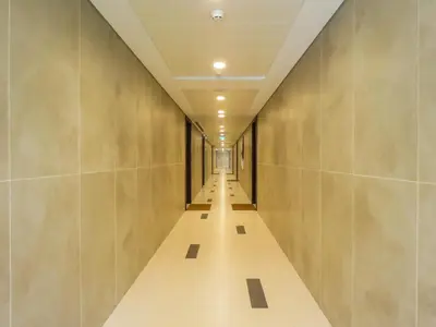 a corridor of a building with a long hallway at OYO 755 Home Sobha Greens in Dubai
