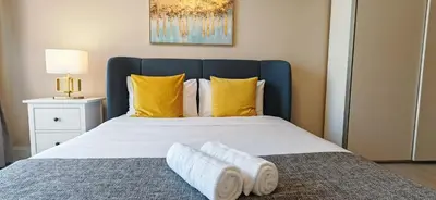 a bedroom with a large bed with yellow pillows at La Buena Vida Holiday Homes, Luxe, 3BR with, full kitchen, Marina View, by JBR Beach, Tram & Marina in Dubai