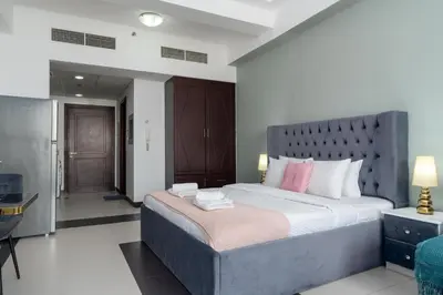 a bedroom with a large bed in a room at Vacay Lettings - Silicon Oasis Budget Friendly Studio in Dubai
