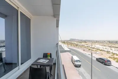 an apartment balcony with a view of a highway at Vacay Lettings - Silicon Oasis Budget Friendly Studio in Dubai