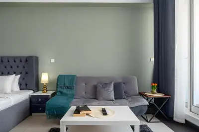 a living room with a couch and a table at Vacay Lettings - Silicon Oasis Budget Friendly Studio in Dubai