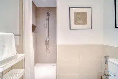 a bathroom with a shower stall and a toilet at Graceful 1BR at Park Heights Dubai Hills MBR City by Deluxe Holiday Homes in Dubai