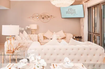a living room with a white couch and a chandelier at Elite Royal Apartment - Panoramic Full Burj Khalifa, Fountain & Skyline view - Imperial - 2 bedrooms & 1 open bedroom without partition in Dubai