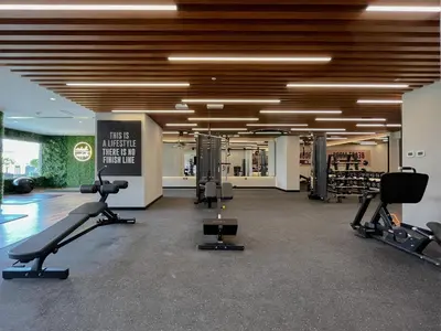 a gym with treadmills and exercise equipment in a building at Trophy - Sky High Haven Suite in Dubai