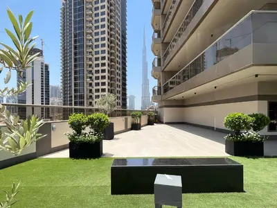 a balcony of a building with grass and plants at Trophy - Sky High Haven Suite in Dubai