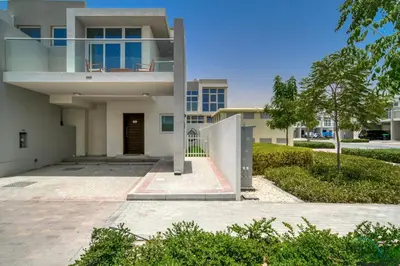 a large white house with a driveway at Cheerful 3BR Townhouse at DAMAC Hills 2, Dubailand by Deluxe Holiday Homes in Dubai