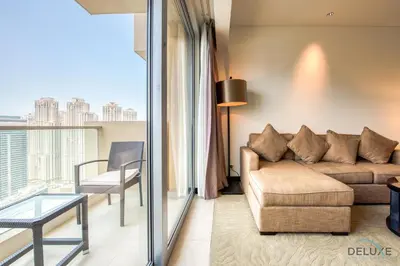a living room with a couch and a table at Lush 1 BR at The Address Residences Dubai Marina by Deluxe Holiday Homes in Dubai