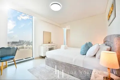 a bedroom with a bed and a large window at LUX 52 42 Deluxe Marina view suite 1 in Dubai
