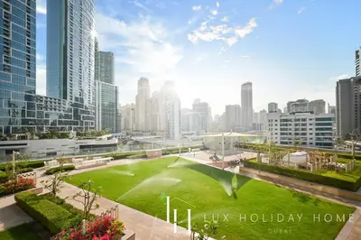 a park in the middle of a city with skyscrapers at LUX 52 42 Deluxe Marina view suite 1 in Dubai