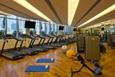 a gym with a row of treadmills and machines at FAHH - Superior 1BHK Address Dubai Mall Residences in Dubai