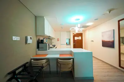 a kitchen with a blue counter and some chairs at FAHH - Superior 1BHK Address Dubai Mall Residences in Dubai