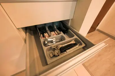 an open drawer in a cabinet with a knife at FAHH - Superior 1BHK Address Dubai Mall Residences in Dubai