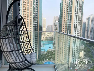 a hammock hanging from a window with a view of a city at Westminster Opera Burj Khalifa in Dubai