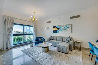 a living room with a couch and a table at Harmony Vacation Homes - North Residence in Dubai