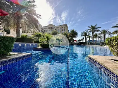 a swimming pool at a resort with a sign on it at Harmony Vacation Homes - North Residence in Dubai