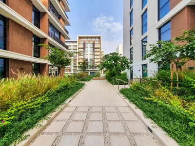 a walkway between two buildings in a city at Brand new 1 bedroom apartment Dubai Hills 601 in Dubai