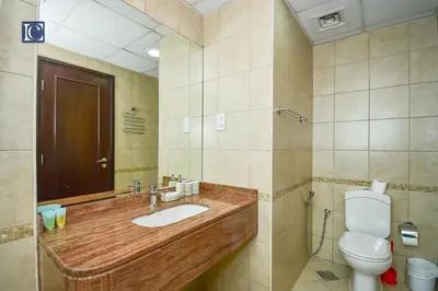 a bathroom with a sink and a toilet at Luxury Escapes - Furnished studio with balcony in Royal Oceanic in Dubai