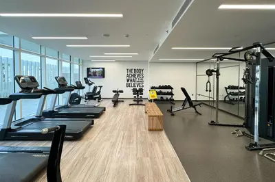 a gym with treadmills and exercise equipment in a building at Tropical Home w Private Beach in Emaar Beachfront in Dubai