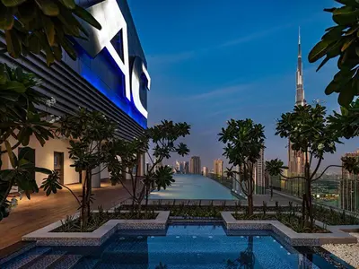 a view of a building with trees and a swimming pool at Paramount Midtown - Fantastic 2 Bedroom Apartment with Sea View in Dubai