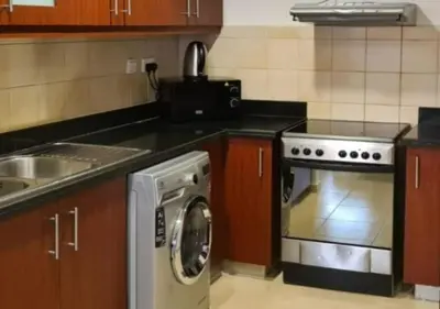 a kitchen with a washing machine and a sink at Spacious 2 BR with Amazing Marina View Rimal JBR in Dubai