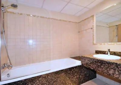 a bathroom with a tub and a sink at Spacious 2 BR with Amazing Marina View Rimal JBR in Dubai