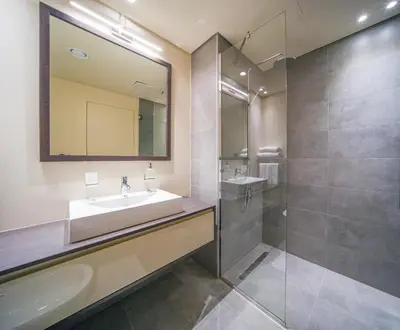 a bathroom with a sink and a shower at Big Modern Studio in Park View JVC in Dubai