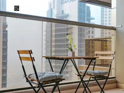 a table and two chairs in front of a window at Mira Holiday Homes - Newly furnished studio in Downtown in Dubai