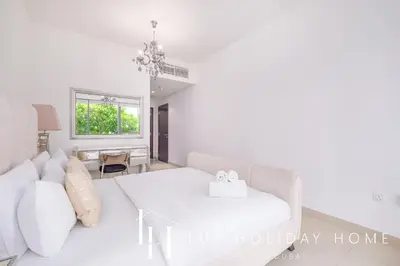 a living room with a white couch and a table at LUX - The Downtown Blvd Suite in Dubai