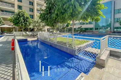 a blue swimming pool in a building at LUX - The Downtown Blvd Suite in Dubai