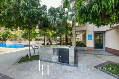 a resort with a swimming pool and a building at LUX - The Downtown Blvd Suite in Dubai