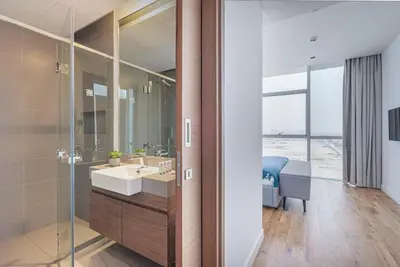 a bathroom with a sink and a glass shower at Vonder: City Walk in Dubai