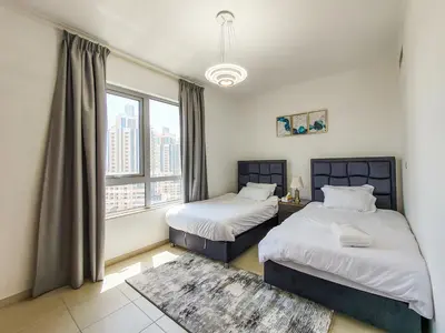 a bedroom with two beds and a large window at The Residence 7 Downtown - Full Burj Khalifa and Fountain Views by Gardenia Suites in Dubai