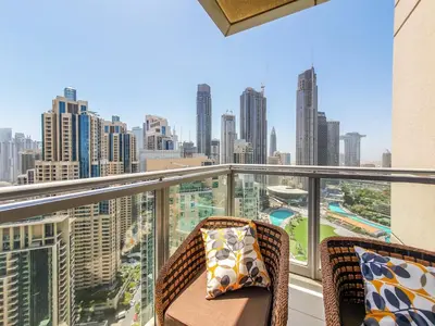 a balcony with two chairs and a view of the city at The Residence 7 Downtown - Full Burj Khalifa and Fountain Views by Gardenia Suites in Dubai