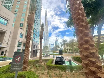 a view of a city with palm trees and buildings at Splendid 3BR Apartments - Burj Khalifa & Fountain Views - 5 Minutes Walk from Dubai Mall in Dubai