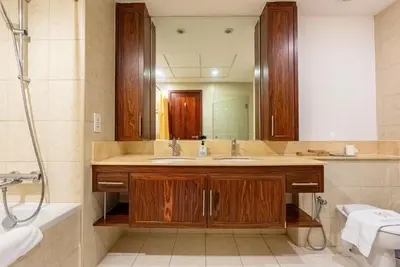 a bathroom with a sink and a large mirror at Splendid 3BR Apartments - Burj Khalifa & Fountain Views - 5 Minutes Walk from Dubai Mall in Dubai