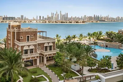 an aerial view of a building with the city in the background at Wyndham Residences The Palm in Dubai
