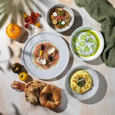 a table with plates of food on a table at Wyndham Residences The Palm in Dubai