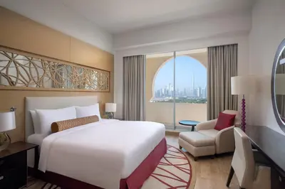 a bedroom with a large white bed and a window at Marriott Executive Apartments Al Jaddaf, Dubai in Dubai