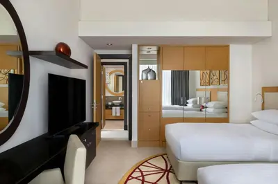 a hotel room with a bed and a television at Marriott Executive Apartments Al Jaddaf, Dubai in Dubai