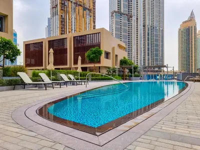 a swimming pool in a city with tall buildings at EDEN'S Homes & Villas - Opera Grand in Dubai