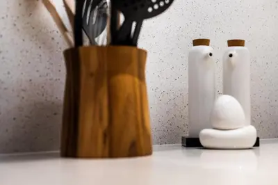 a vase with utensils in it on a counter at EDEN'S Homes & Villas - Opera Grand in Dubai