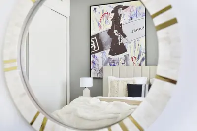 a mirror reflection of a bed in a bedroom at The Smart Concierge - Beach Vista 2 in Dubai