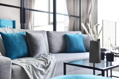 a living room with a couch and a table at GuestReady - In the Heart of Dubai Hills in Dubai