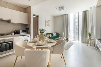 a kitchen and living room with a table and chairs at Frank Porter - Sobha Creek Tower B in Dubai